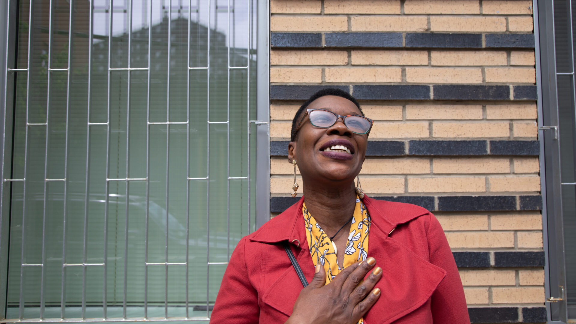 Carine standing smiling looking up at the sky.