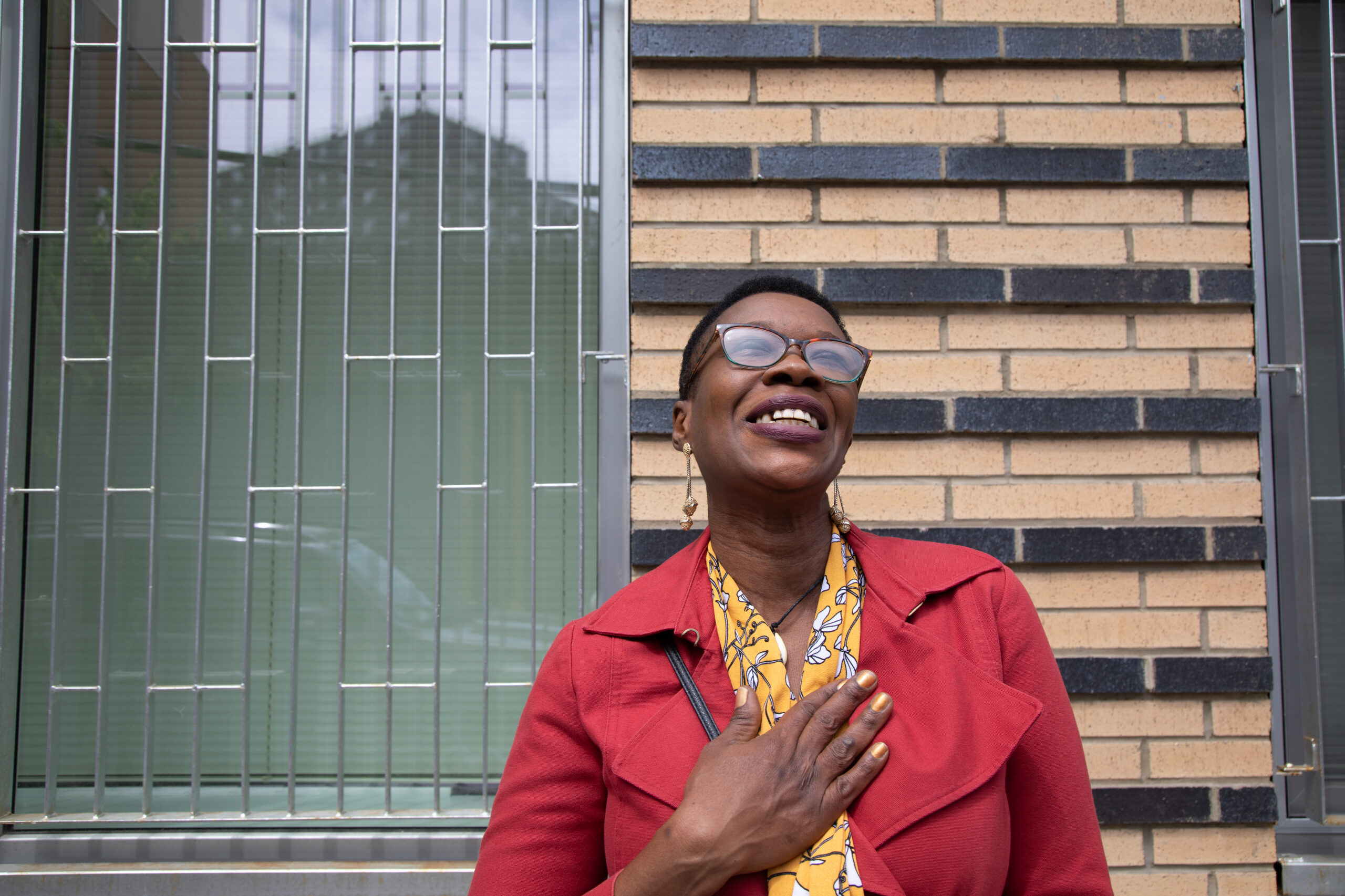 Carine standing smiling looking up at the sky.