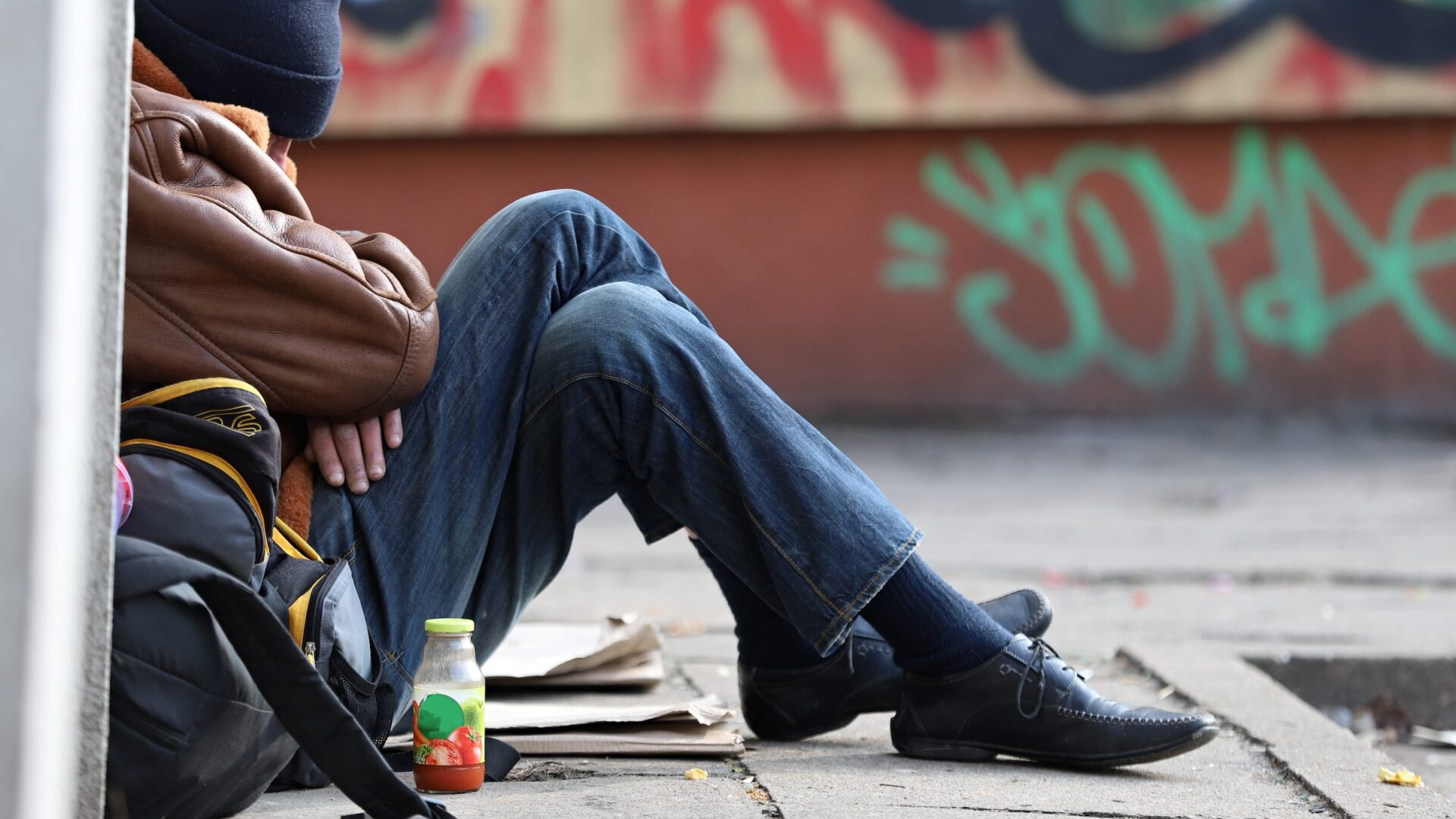 man sleeping on the sidewalk