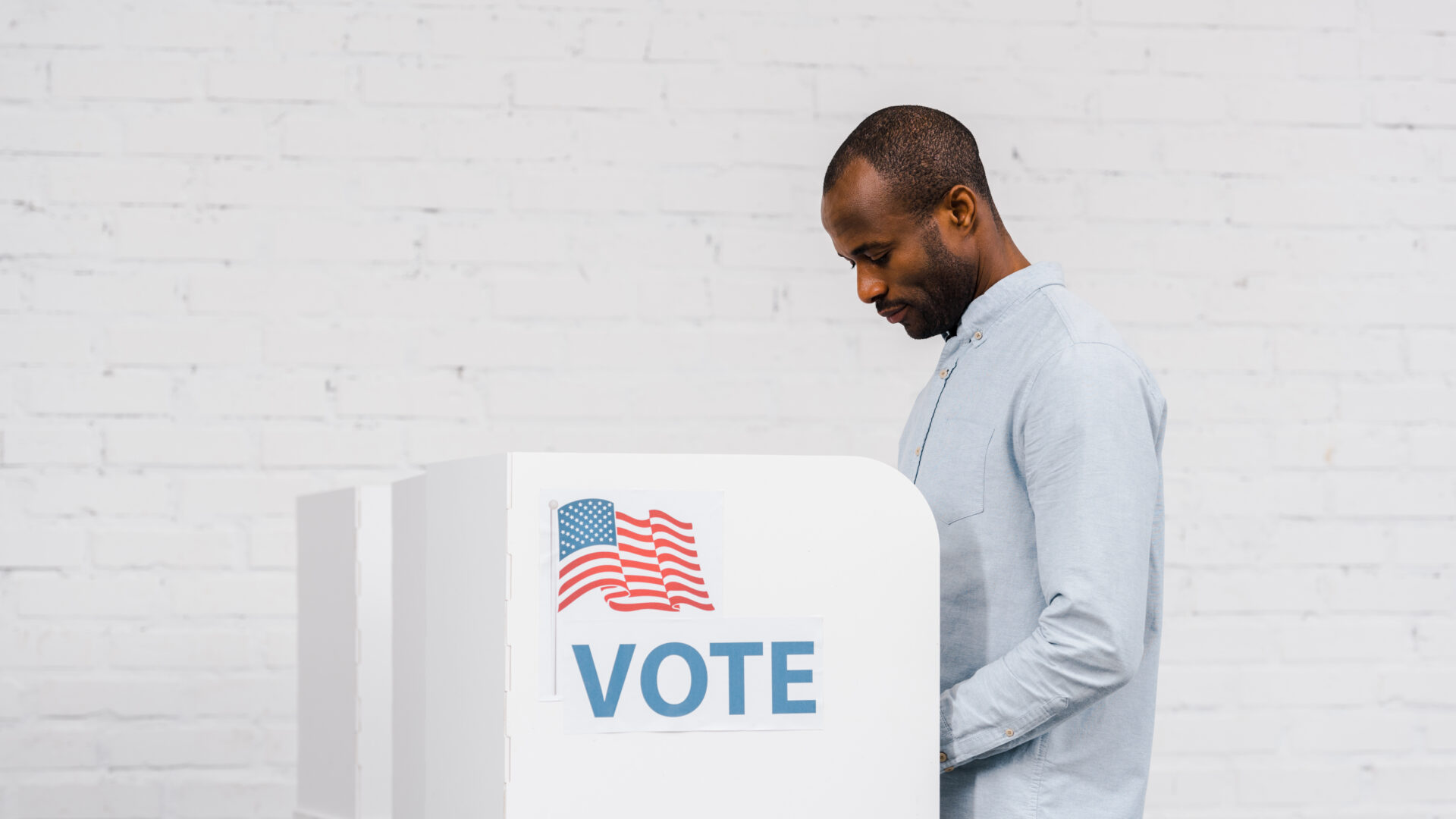 Black man voting against a white background