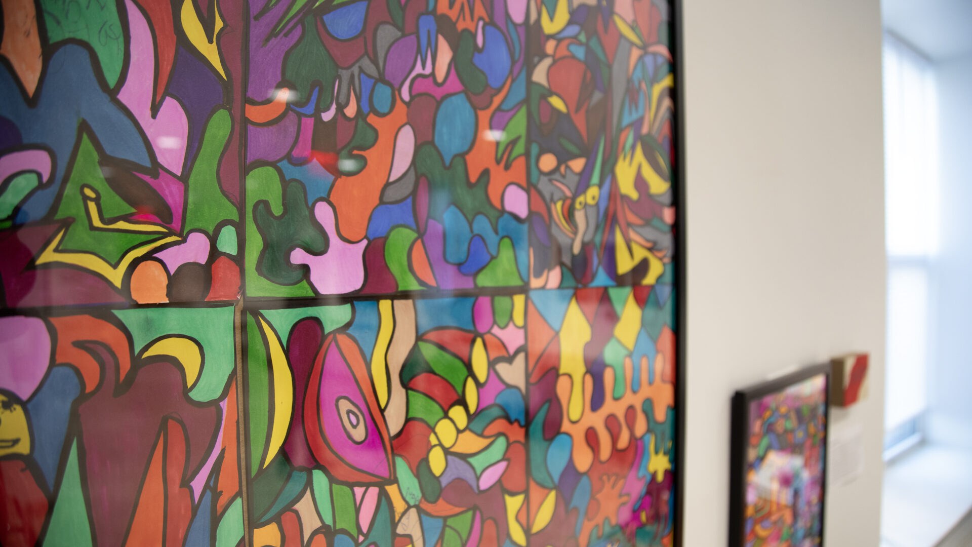 Colorful abstract art framed on the wall.