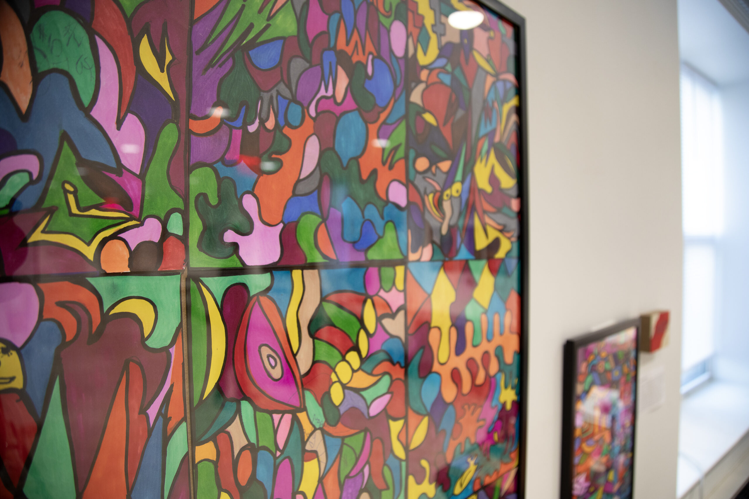 Colorful abstract art framed on the wall.