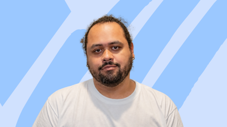 Man with beard in white shirt with light blue gradient backpground.