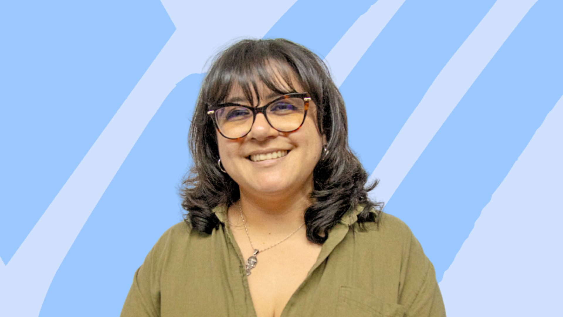 Smiling woman with a green top against a blue gradient background.