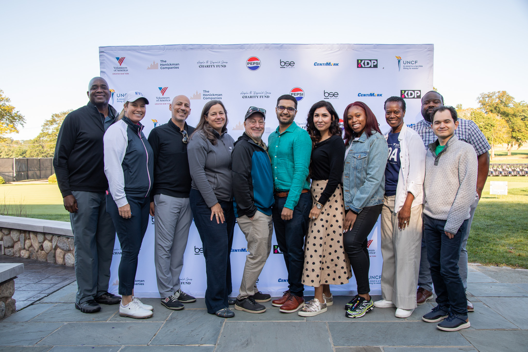 A group photo of Reginald Goins, Brittany Lincicome, and VOA-GNY staff.