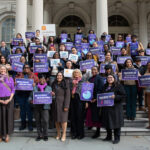 VOA-GNY staff joins City Council Majority Leader Amanda Farías on the steps of City Hall.